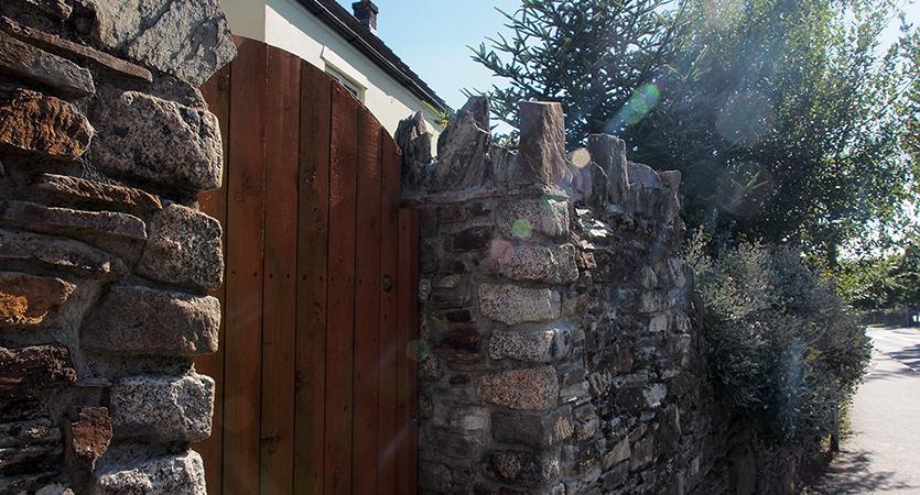 Stone wall and wooden gateway in Liskeard